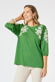 A model wearing the Jill Embroidered Cotton Tee in colour Elm (Green), from the front, cropped image