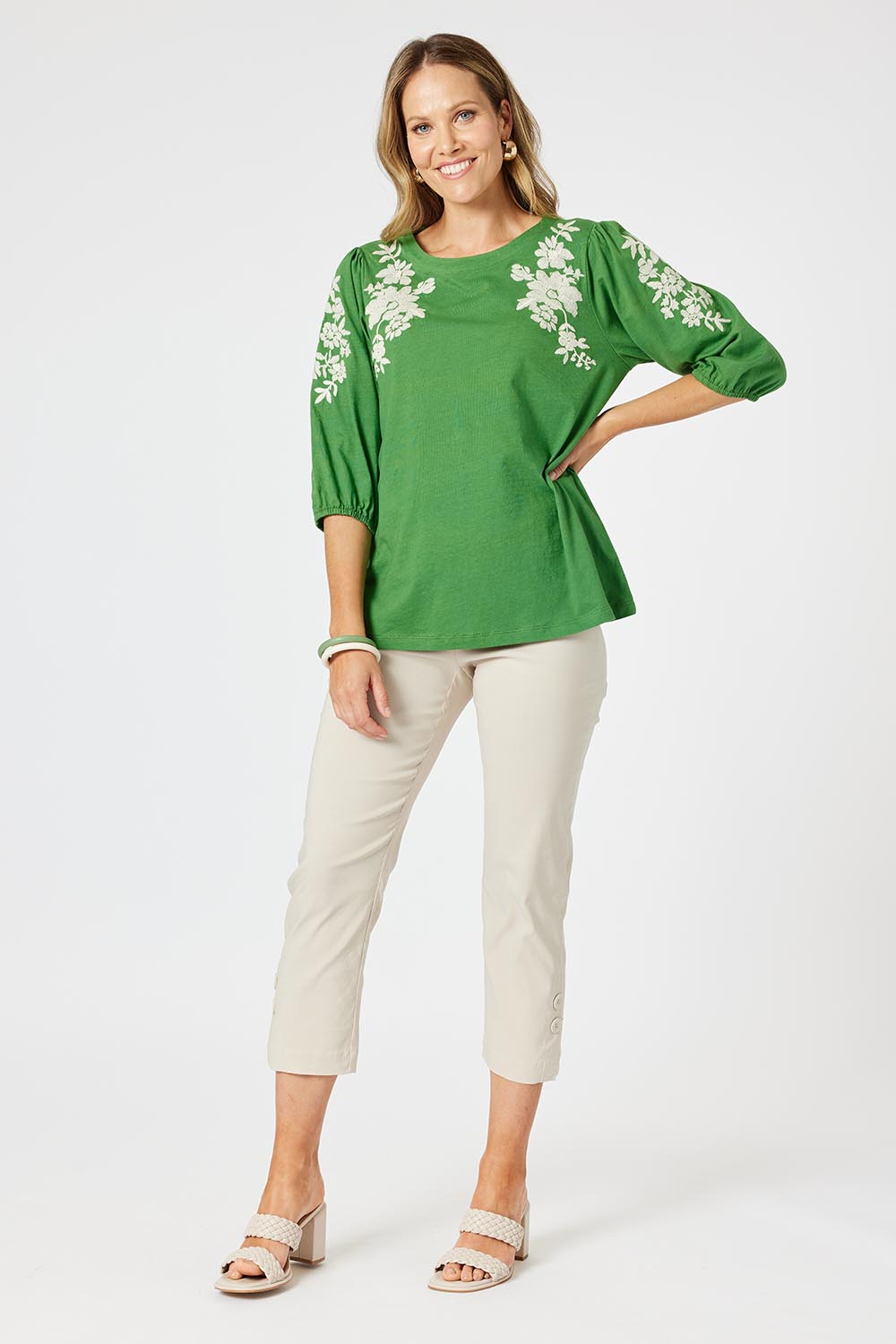 A model wearing the Jill Embroidered Cotton Tee in colour Elm (Green), from the front, showing the whole outfit