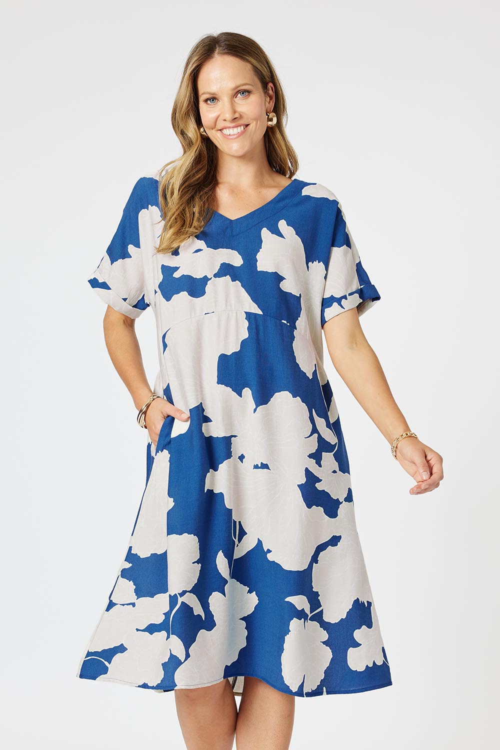 A model wearing the Barcelona Dress in colour Blue (Blue), from the front, cropped image