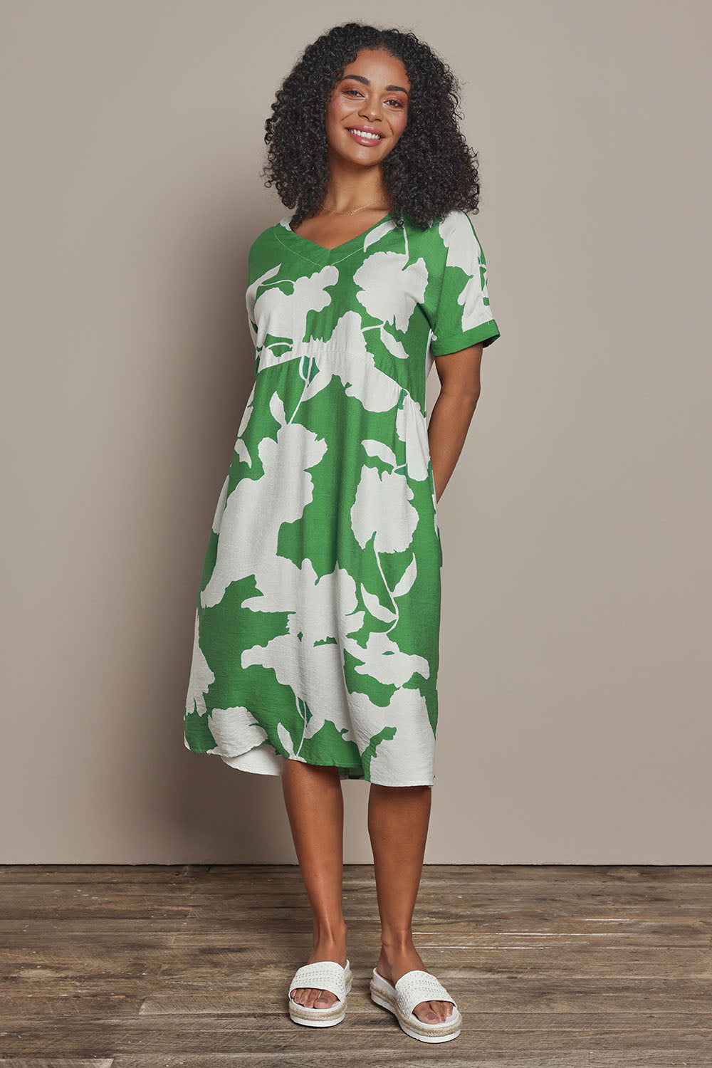 Model Ziara wearing size S of the Barcelona Dress in colour Elm (Green), from the front, showing the whole outfit