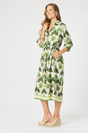 A model wearing the Amazon Print Dress in colour Green (Green), from the front, showing the whole outfit
