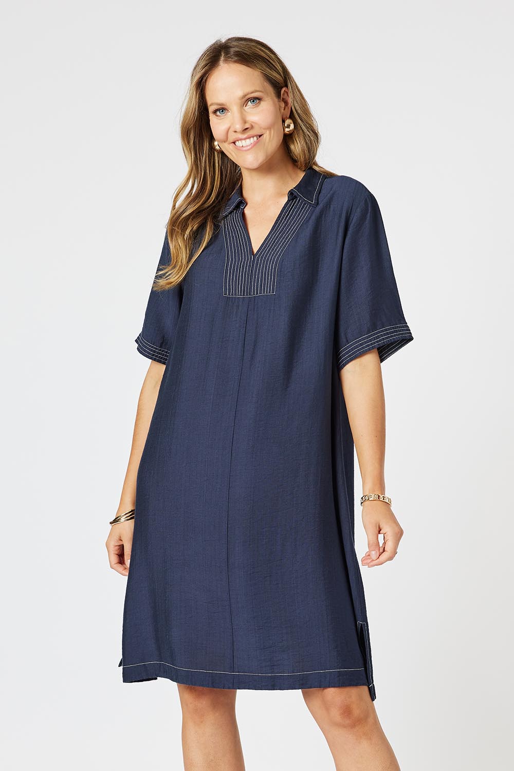 A model wearing the Top Stitch Dress in colour Navy (Blue), from the front, cropped image