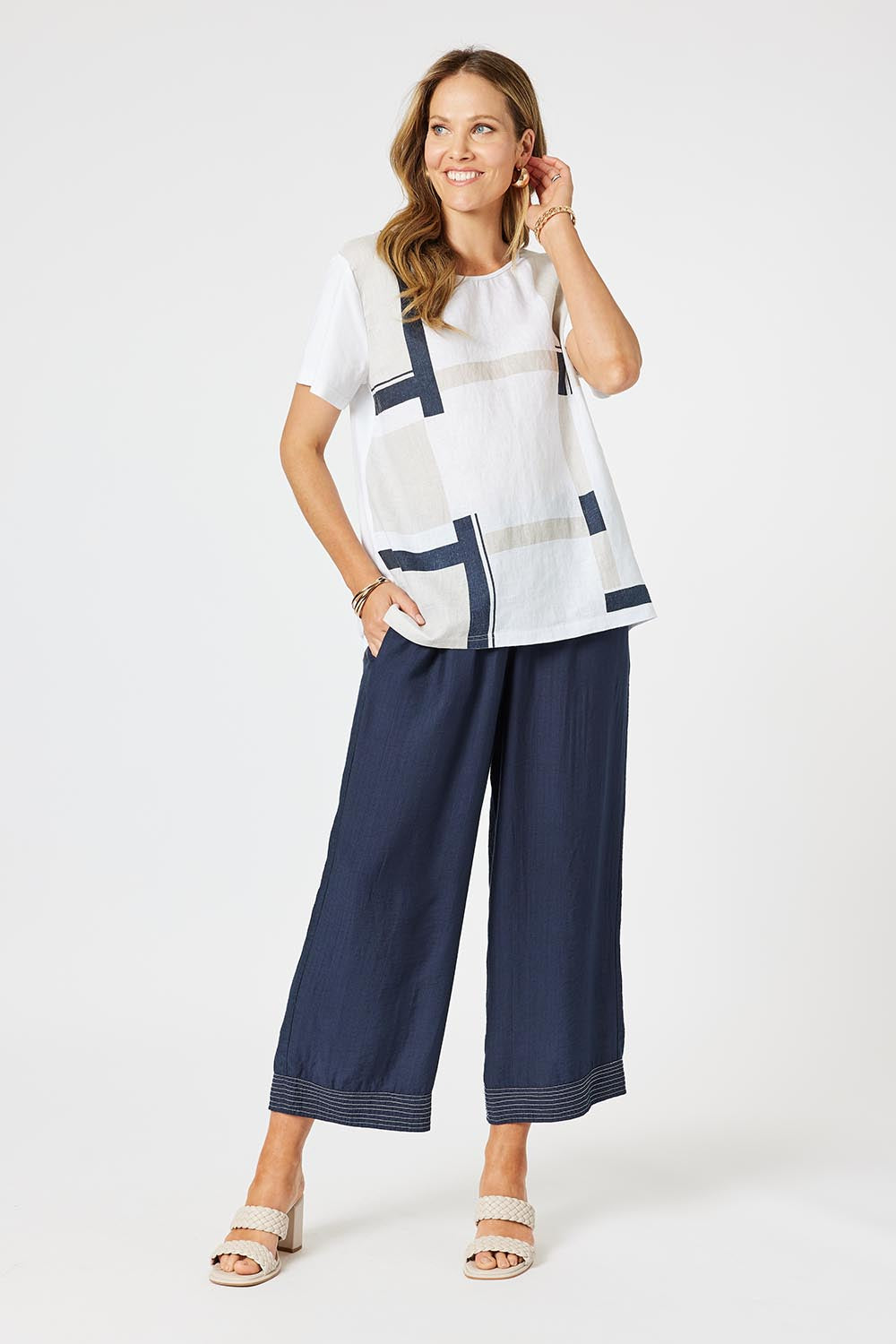 A model wearing the Top Stitch Pant in colour Navy (Blue), from the front, showing the whole outfit