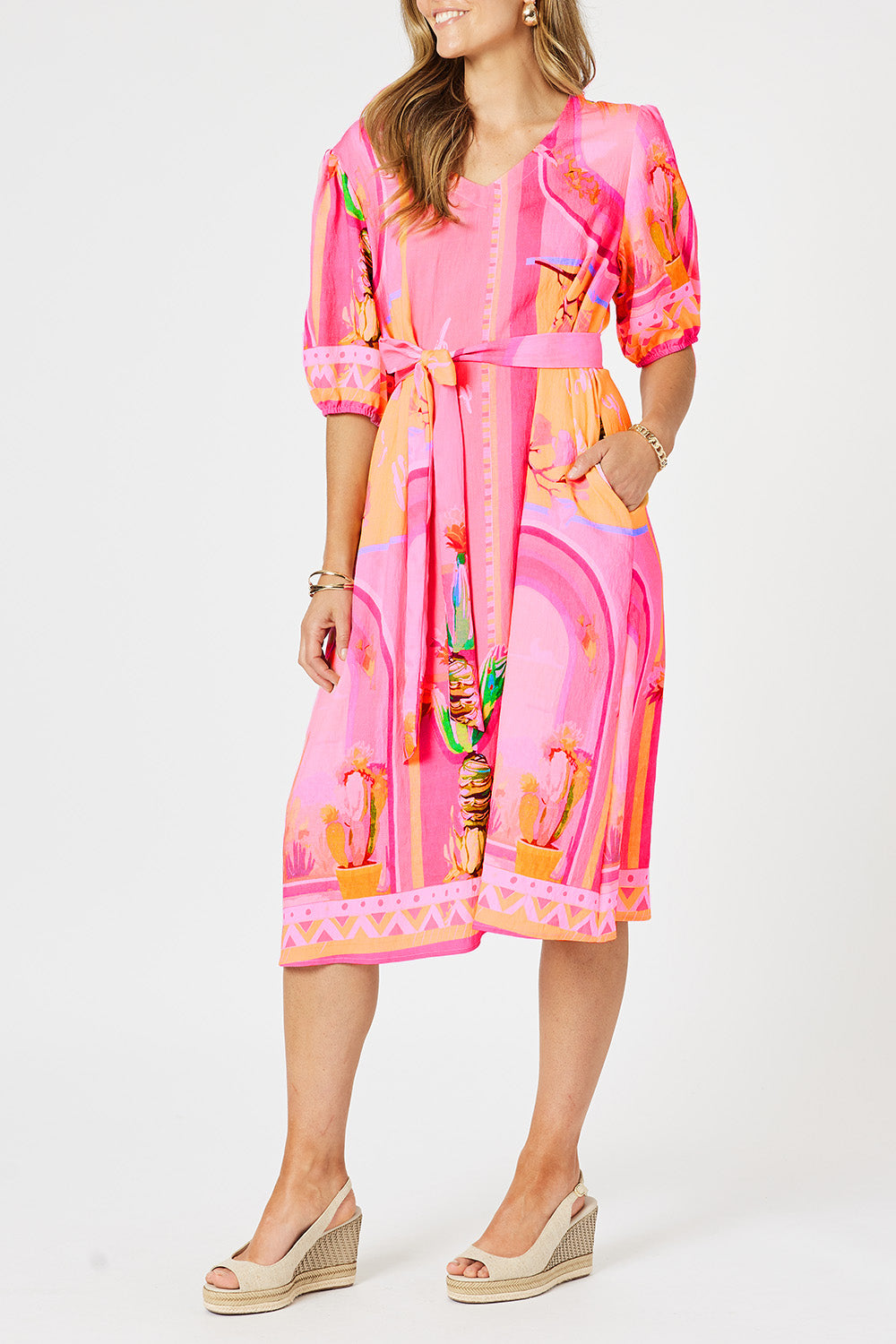 A model wearing the Tulum Dress in colour Pink (Pink), from the front, cropped image
