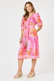 A model wearing the Tulum Dress in colour Pink (Pink), from the front, showing the whole outfit