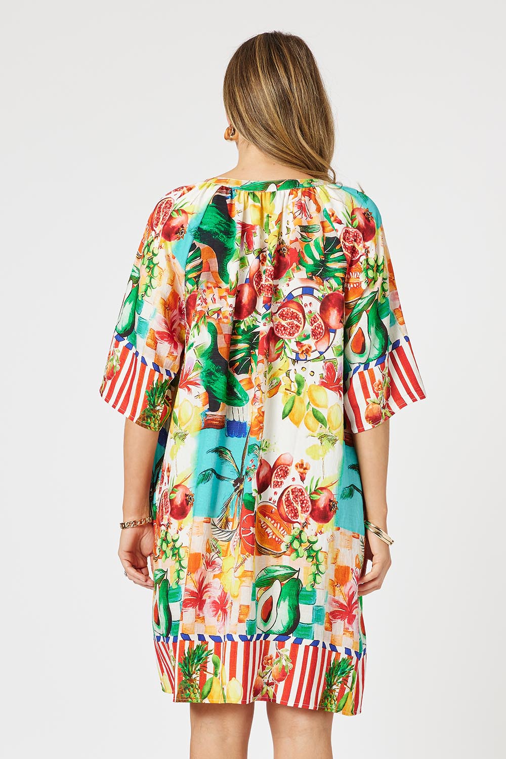 A model wearing the Positano Dress in colour Multi, from the back