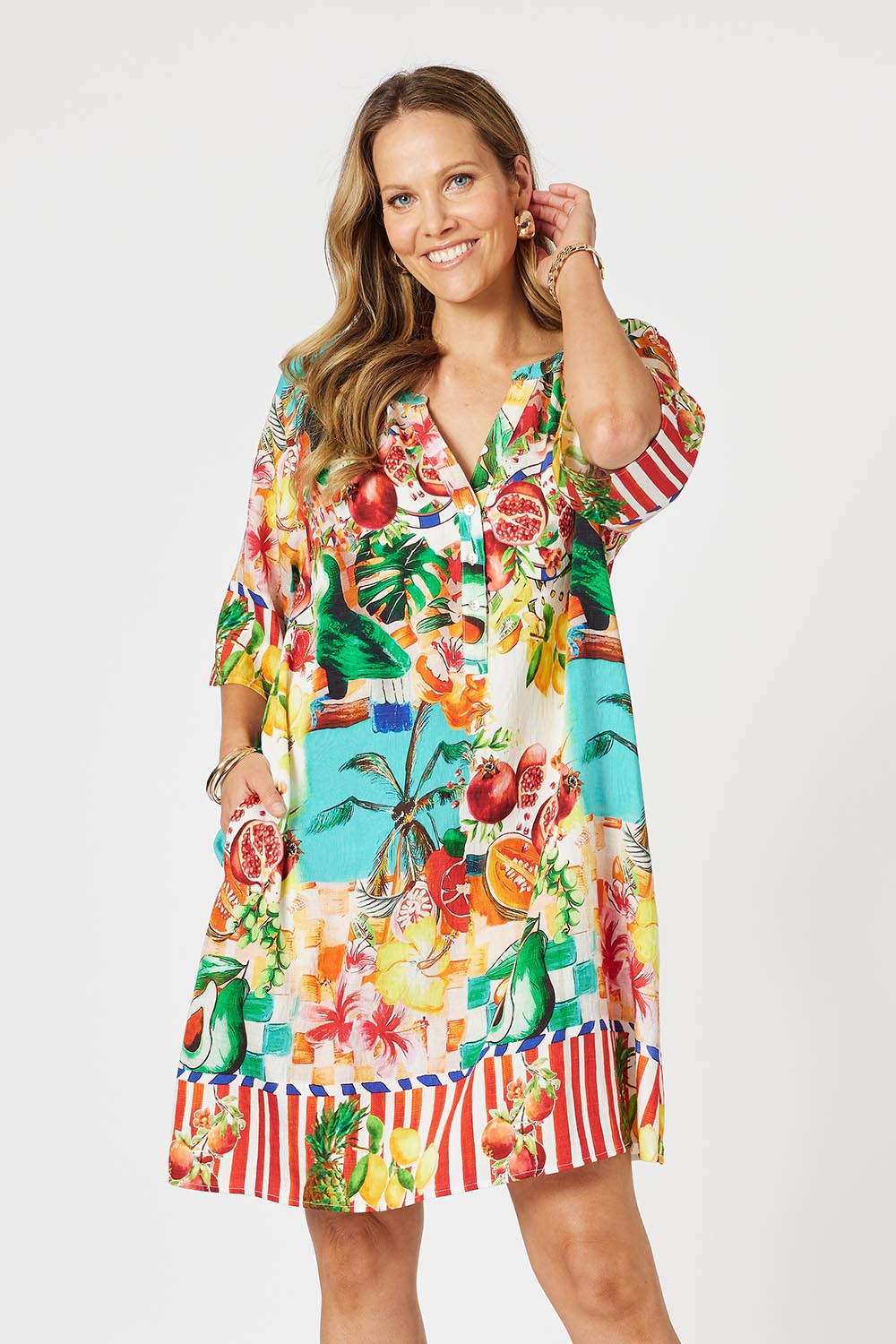A model wearing the Positano Dress in colour Multi, from the front, cropped image
