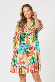 A model wearing the Positano Dress in colour Multi, from the front, cropped image