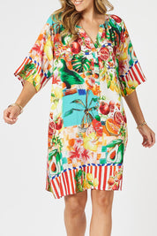 A model wearing the Positano Dress in colour Multi, from the front, cropped image