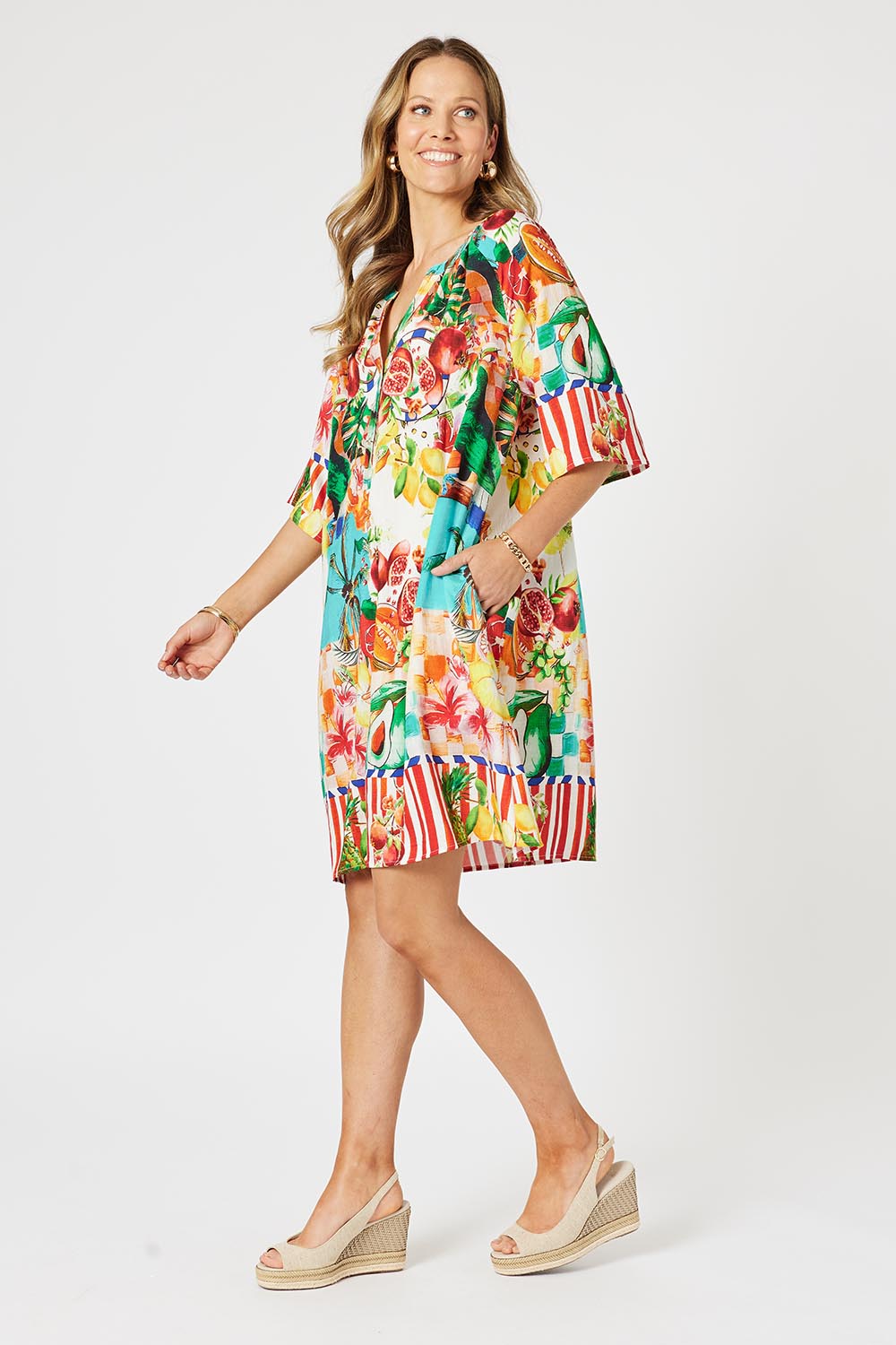 A model wearing the Positano Dress in colour Multi, from the front, showing the whole outfit