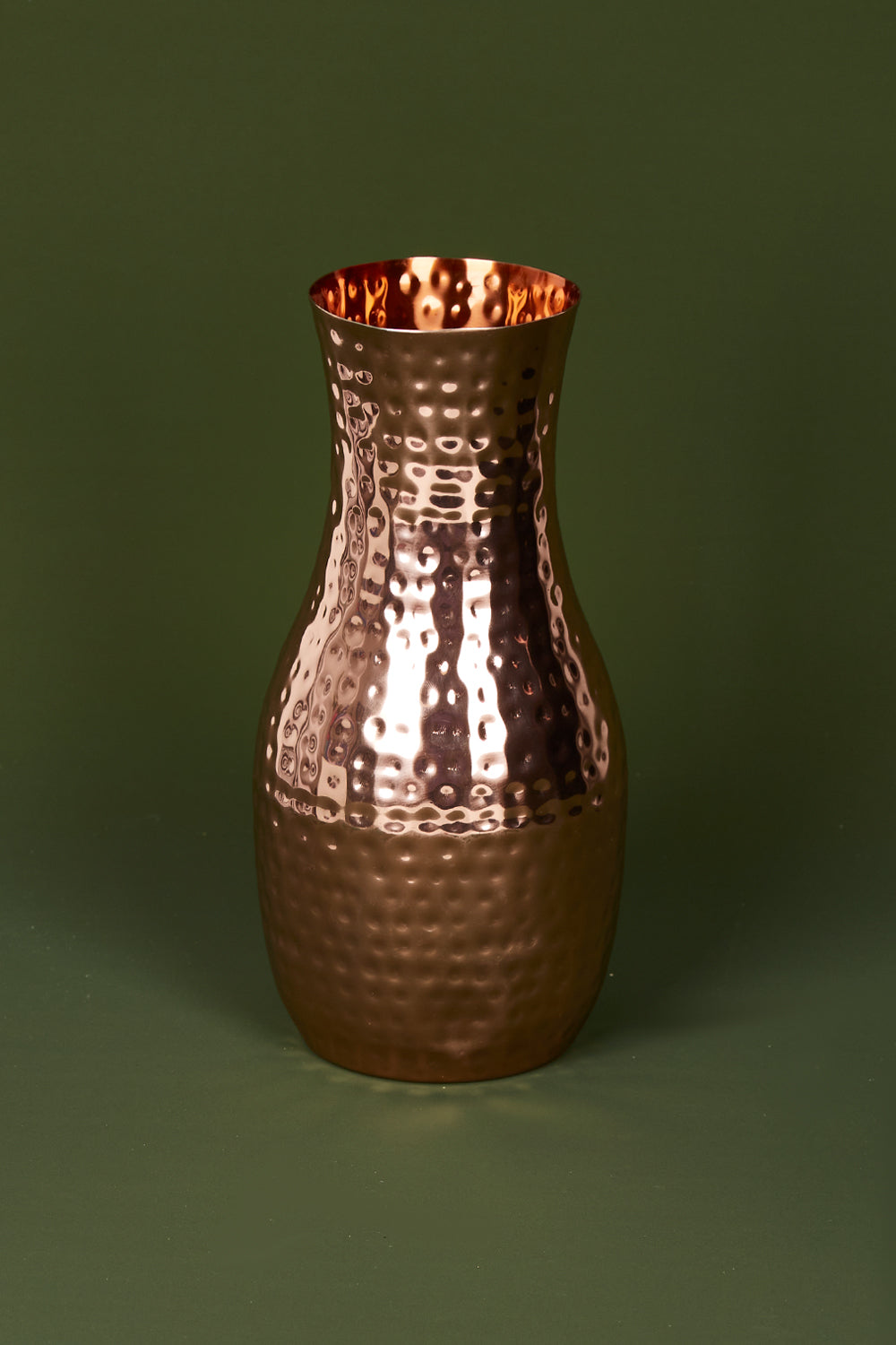 A model wearing size OneSize of the Boxed Hammered Copper Carafe in colour Copper (Metallics), from the front, showing the whole outfit