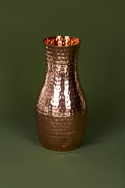 A model wearing size OneSize of the Boxed Hammered Copper Carafe in colour Copper (Metallics), from the front, showing the whole outfit