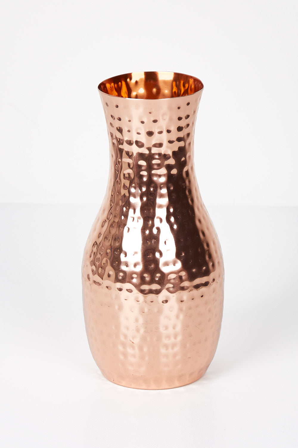A model wearing size OneSize of the Boxed Hammered Copper Carafe in colour Copper (Metallics), from the front, showing the whole outfit