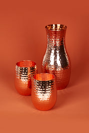 A model wearing size OneSize of the Boxed Hammered Copper Carafe in colour Copper (Metallics), from the front, showing the whole outfit