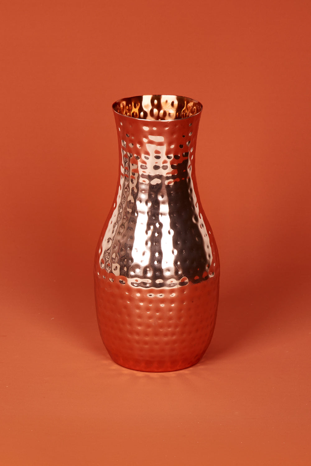 A model wearing size OneSize of the Boxed Hammered Copper Carafe in colour Copper (Metallics), from the front, showing the whole outfit