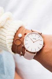 A model wearing the La Boheme Rose Gold Watch in colour WhitePink (Pink), from the front, showing the whole outfit