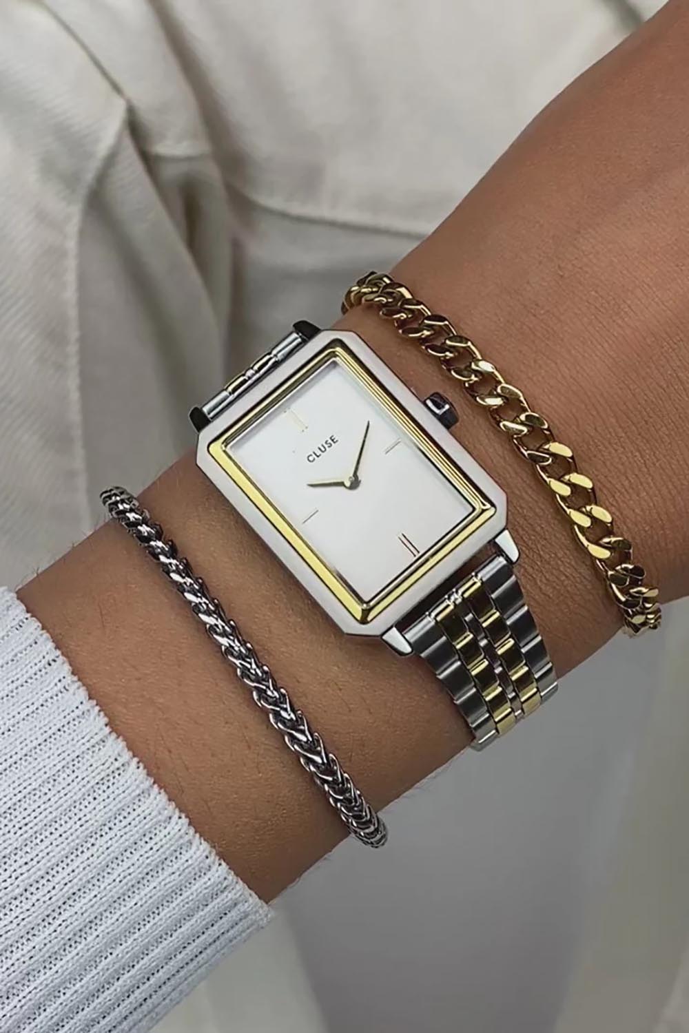 A model wearing the Fluette Bicolour Watch in colour Silvergold (Metallics), from the front, cropped image