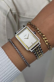A model wearing the Fluette Bicolour Watch in colour Silvergold (Metallics), from the front, cropped image