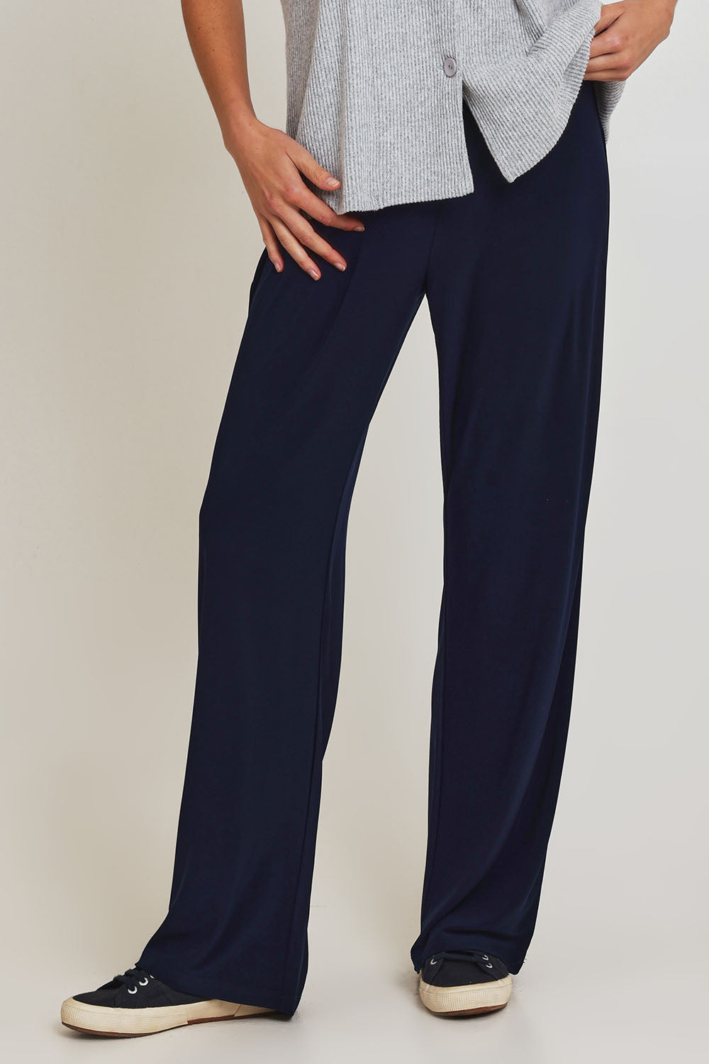Model Madeline wearing size 10 of the Travel Wide Leg Pant in colour Navy (Blue), from the front, cropped image
