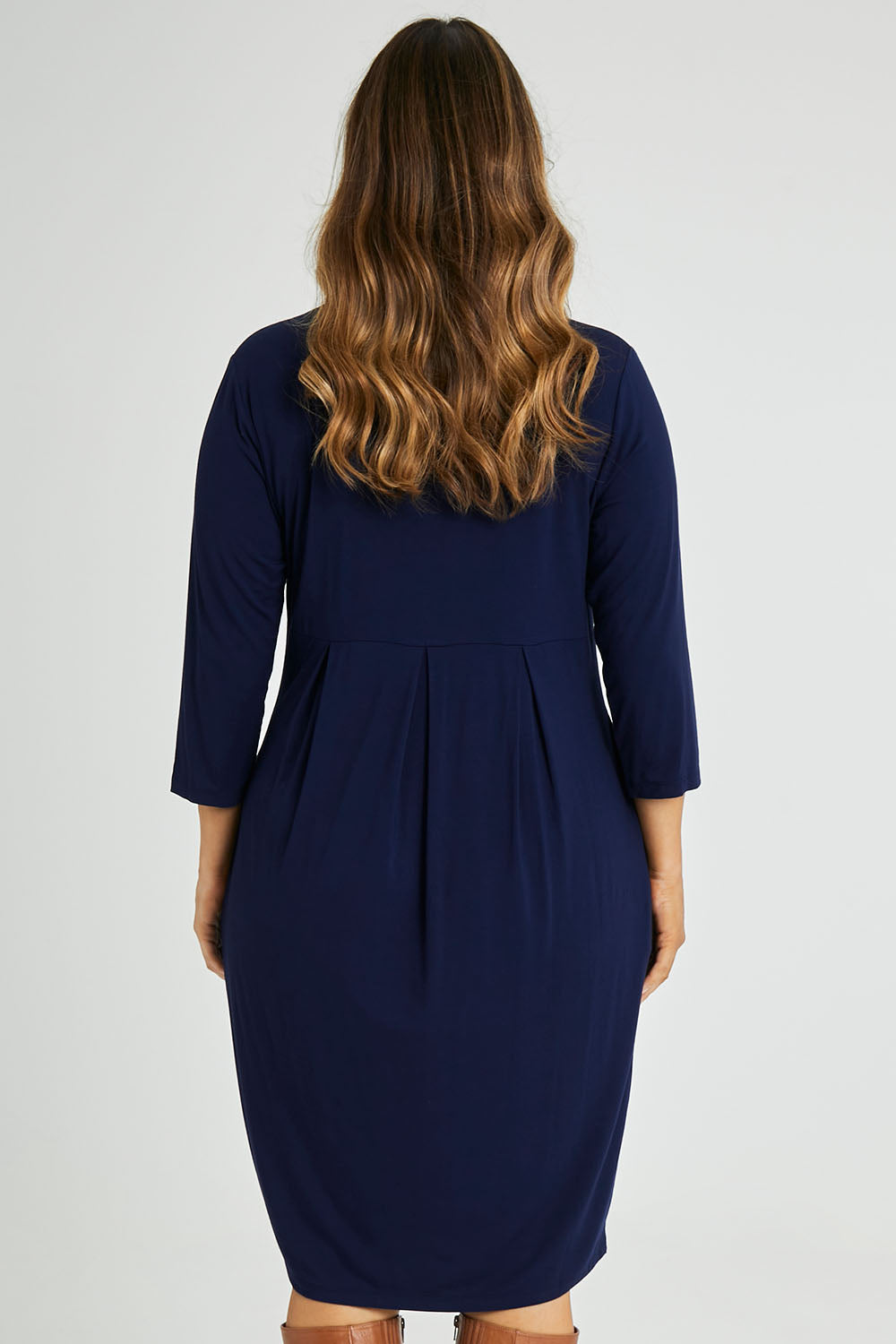 Model Laura wearing size 14 of the Box Pleat Dress in colour Navy (Blue), from the back