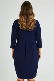 Model Laura wearing size 14 of the Box Pleat Dress in colour Navy (Blue), from the back