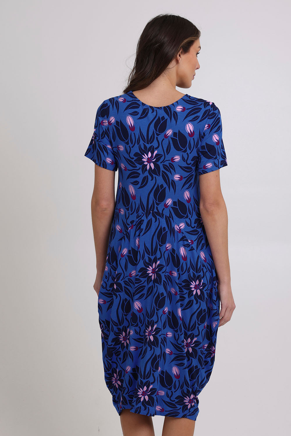 Model Madeline wearing size 10 of The Bounce Dress in colour Blue (Blue), from the back