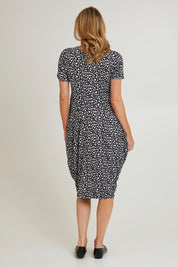 Model Grace wearing size 10 of the Cap Sleeve Bounce Dress in colour Blkwhite (Black), from the back