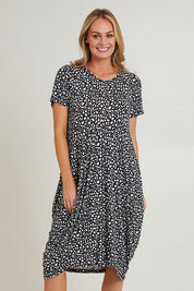 Model Grace wearing size 10 of the Cap Sleeve Bounce Dress in colour Blkwhite (Black), from the front, cropped image