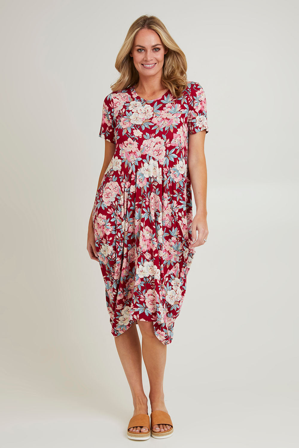 Model Grace wearing size 10 of the Cap Sleeve Bounce Dress in colour Cherry (Red), from the front, showing the whole outfit
