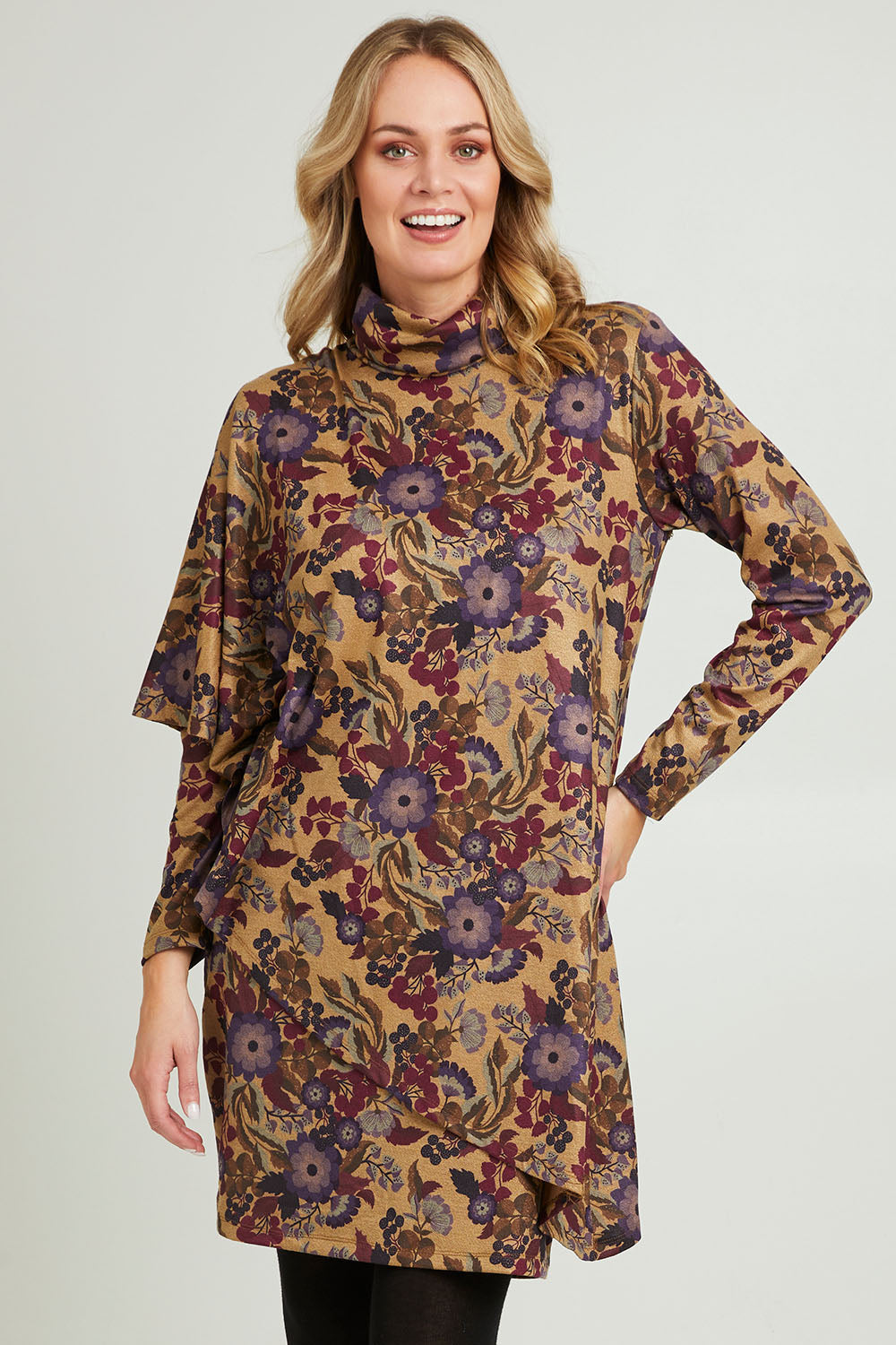 Model Grace wearing size 10 of the Printed Cape Dress in colour Plum, from the front, cropped image