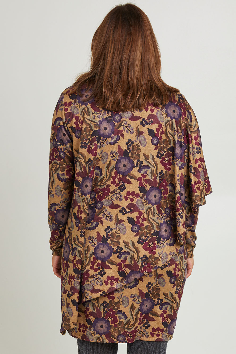 Model Monique wearing size 14 of the Printed Cape Dress in colour Plum, from the back