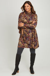 Model Monique wearing size 14 of the Printed Cape Dress in colour Plum, from the front, showing the whole outfit
