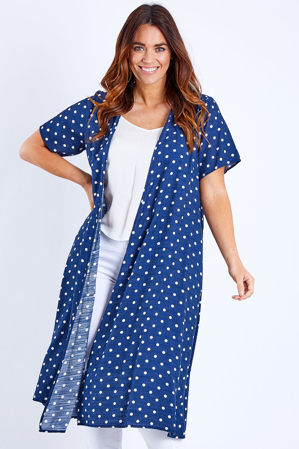 Model Laura wearing size 14 of the Dotty Jacket in colour Navyspot (Blue), from the front, cropped image