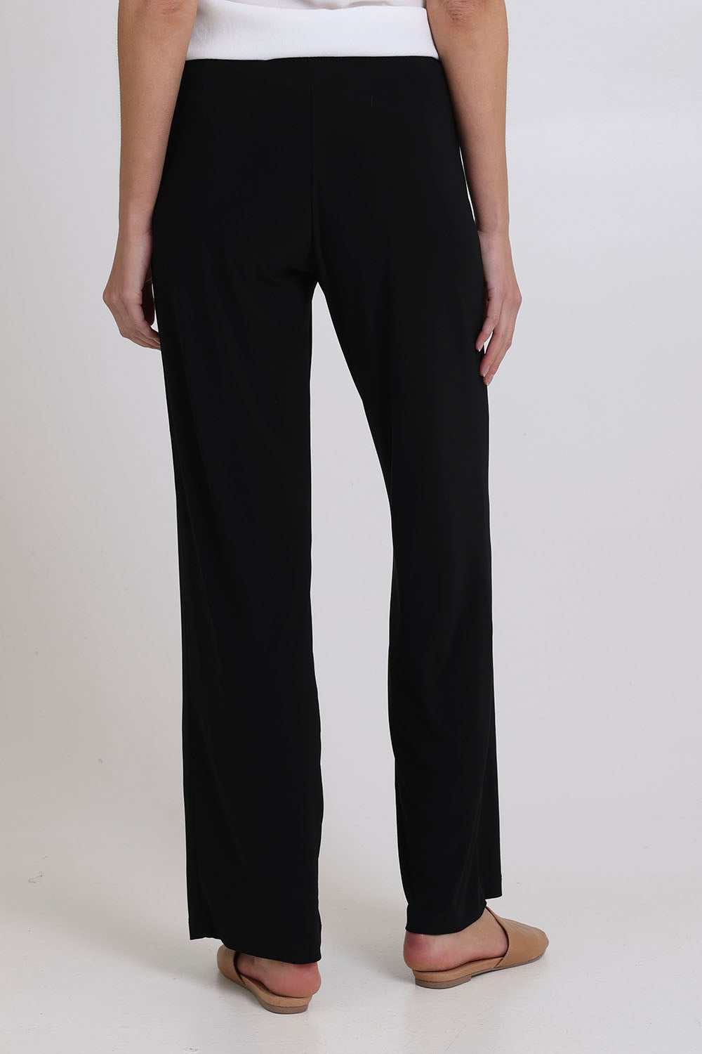 Model Madeline wearing size 10 of the Classic Travel Pant in colour Black (Black), from the back