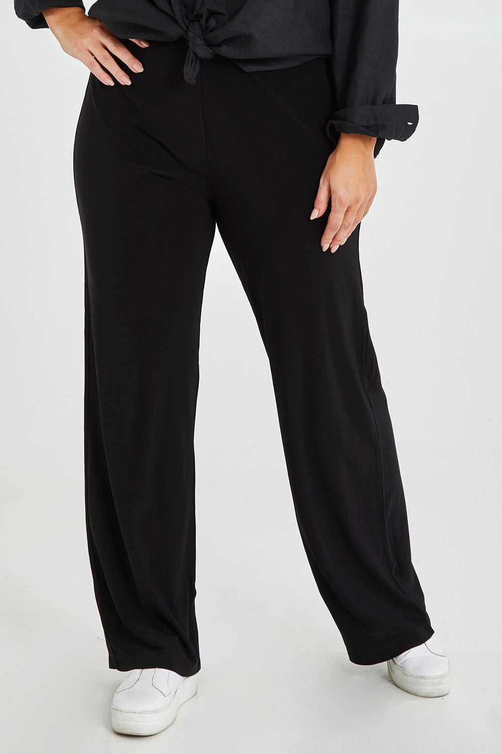 Model Monique wearing size 14 of the Classic Travel Pant in colour Black (Black), from the front, cropped image