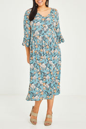 Model Terri-Leigh wearing size 14 of the Gemma Ruffle Dress in colour Mint (Green), from the front, cropped image