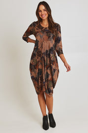 Model Madeline wearing size 10 of the Bounce Dress in colour Green, from the front, showing the whole outfit