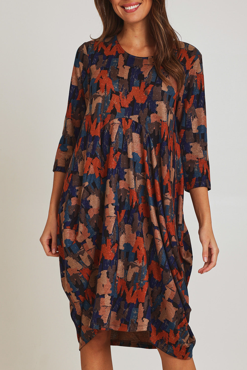 Model Madeline wearing size 10 of the Bounce Dress in colour Multi, from the front, cropped image