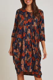 Model Madeline wearing size 10 of the Bounce Dress in colour Multi, from the front, cropped image