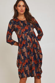 Model Madeline wearing size 10 of the Bounce Dress in colour Multi, from the front, cropped image