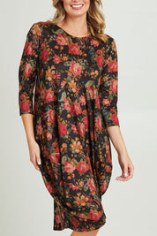 Model Grace wearing size 10 of the Bounce Dress in colour Paisley (Black), from the front, cropped image