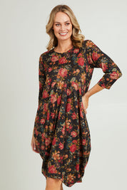 Model Grace wearing size 10 of the Bounce Dress in colour Paisley (Black), from the front, cropped image
