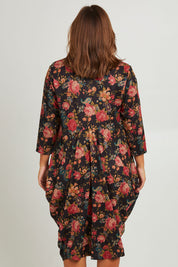 Model Monique wearing size 14 of the Bounce Dress in colour Paisley (Black), from the back