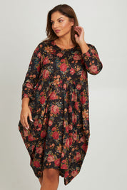 Model Monique wearing size 14 of the Bounce Dress in colour Paisley (Black), from the front, cropped image