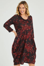 Model Jess wearing size 14 of the Bounce Dress in colour Paperred (Green), from the front, cropped image