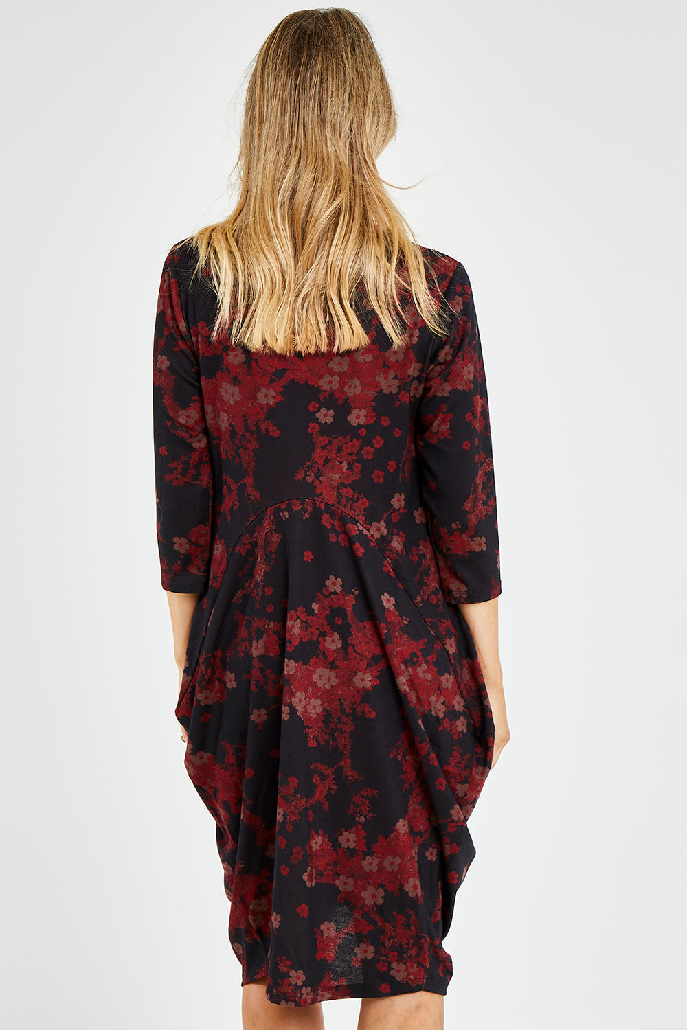 Model Kelly wearing size 10 of the Bounce Dress in colour Paperred (Green), from the back