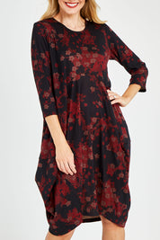 Model Kelly wearing size 10 of the Bounce Dress in colour Paperred (Green), from the front, cropped image