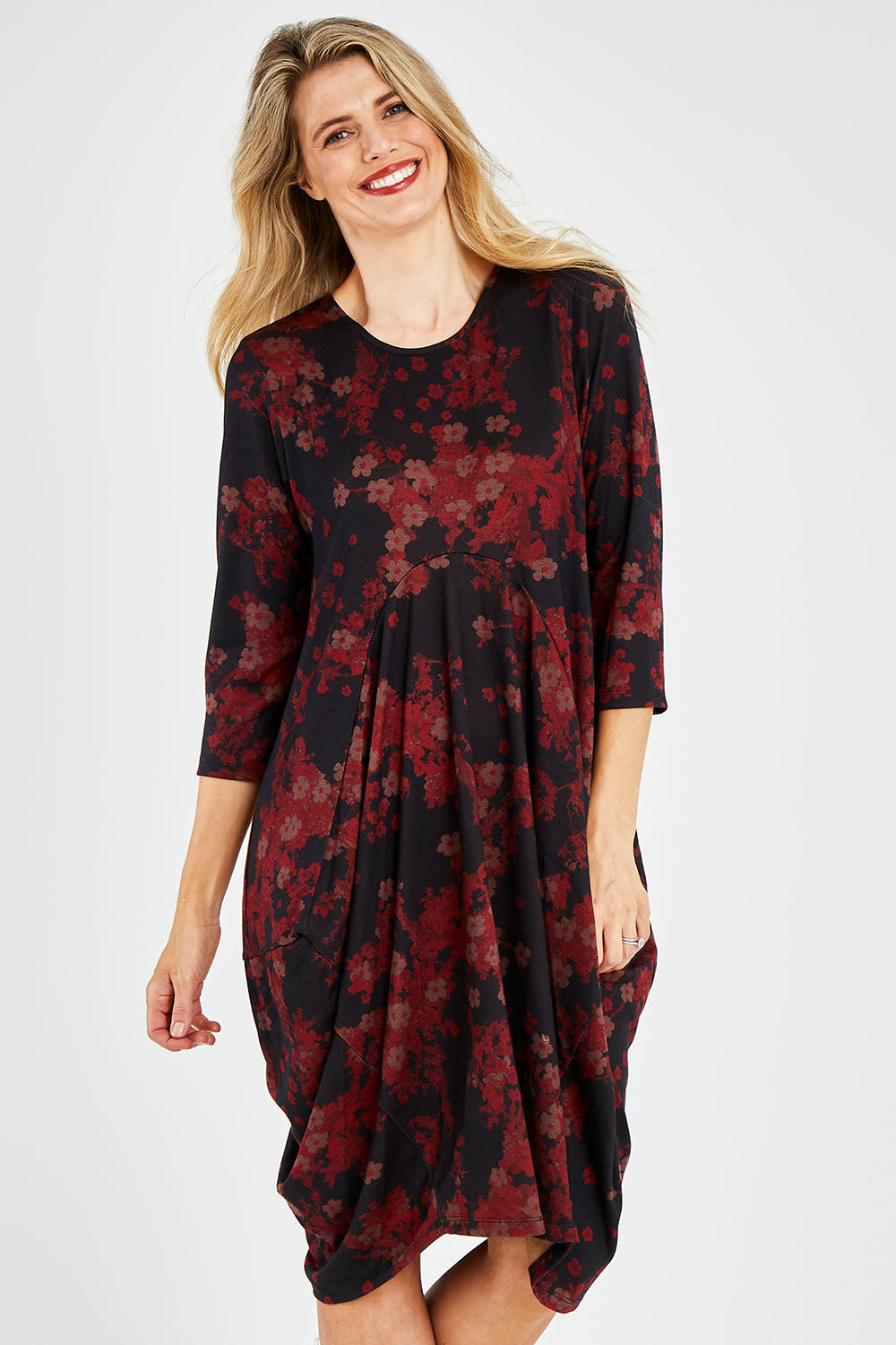 Model Kelly wearing size 10 of the Bounce Dress in colour Paperred (Green), from the front, cropped image