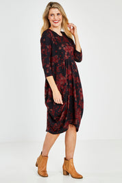 Model Kelly wearing size 10 of the Bounce Dress in colour Paperred (Green), from the front, showing the whole outfit
