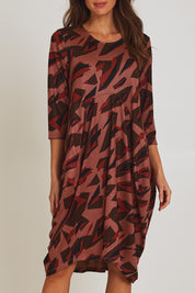 Model Madeline wearing size 10 of the Bounce Dress in colour Pinkred (Pink), from the front, cropped image